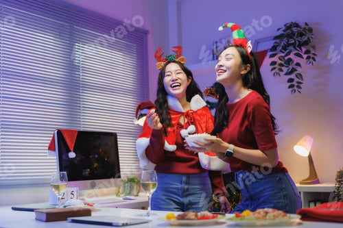 Preview: Friends celebrating christmas party laughing together