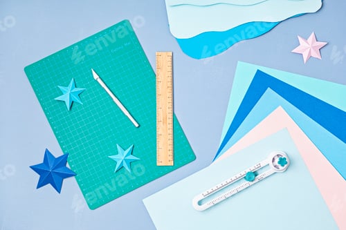 Preview: Top view over paper cut tools, scissors, cutter, cutting mat and paper