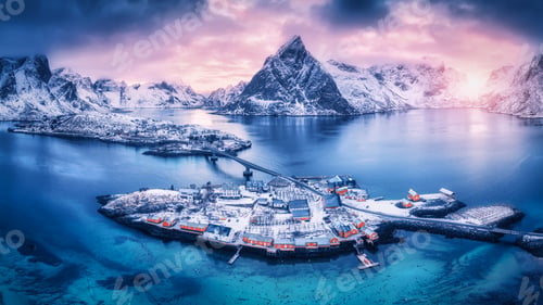 Preview: Aerial view of snowy islands with houses, rorbu, blue sea