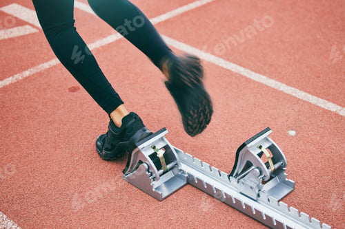 Preview: Feet, running and race start blocks with woman athlete on stadium, motion blur and speed, action an