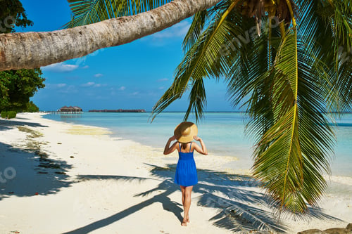 Preview: Woman In Blue Dress On A Tropical Beach At Maldives
