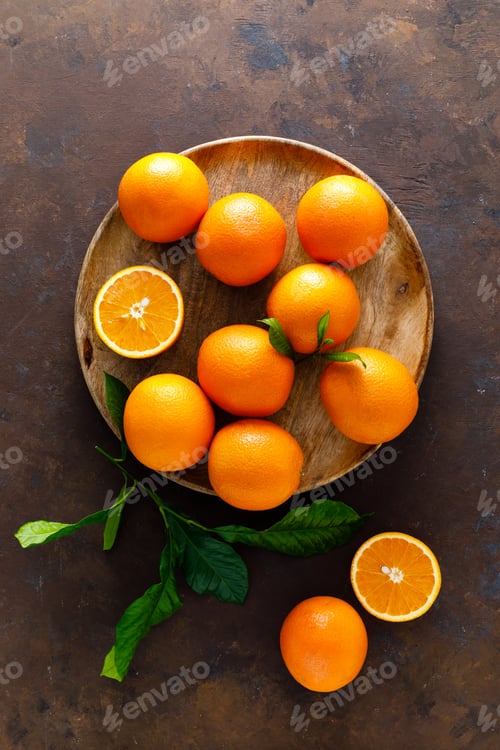 Preview: Oranges with leaves on dark background, top view