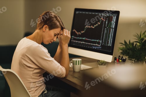 Preview: Woman Experiencing Stress During A Late Night Analyzing Crypto Graph From Home