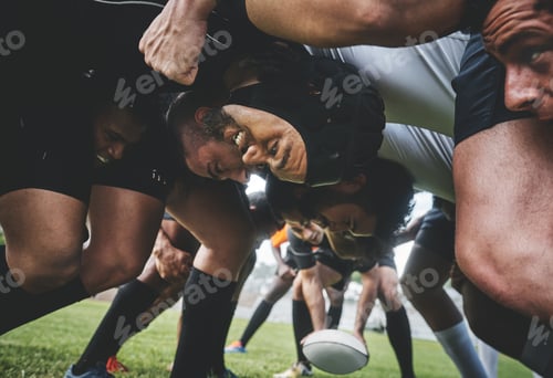 Preview: Low angle shot of two young rugby teams competing in a scrum during a rugby match on a field