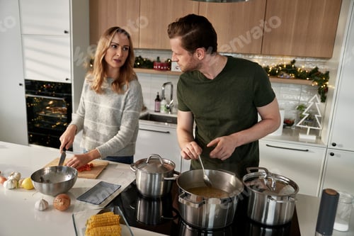 Preview: Caucasian couple cooking together before Christmas and chatting