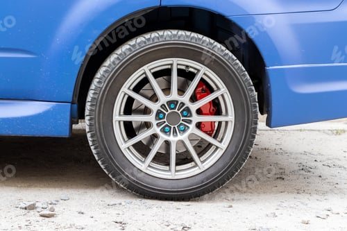 Preview: Stylish blue car wheel with red brake caliper and five-nut rim. Brake system support
