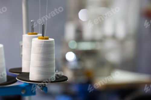 Preview: Spools of white threads on sewing machine, closeup
