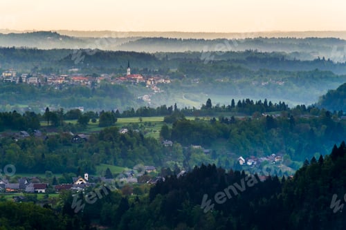 Preview: Misty sunrise landscape view from Osojnica Hill at Lake Bled towards the Church of St Peter at Radov
