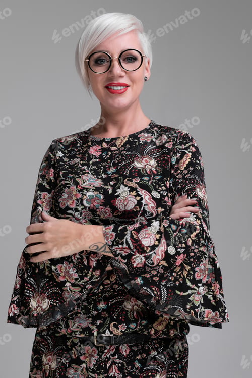 Preview: Portrait of young blonde girl with glasses isolated on light background