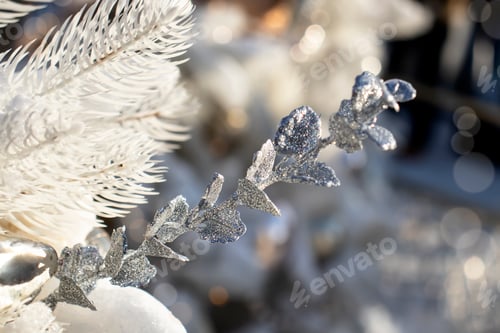 Preview: Christmas tree decorated with white balls and toys in the snow