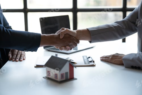 Preview: Two young Asian businessmen shake hands after signing a contract to invest in a village project. rea