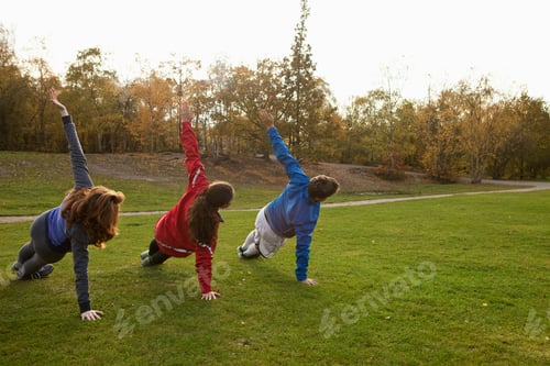 Preview: Three friends doing cartwheels in a park at sunset