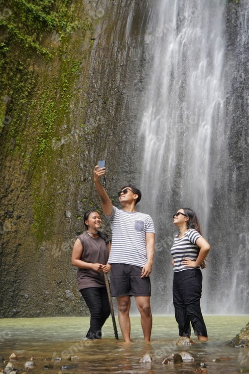 Preview: small group of young asian indonesian man and woman taking selfie photos