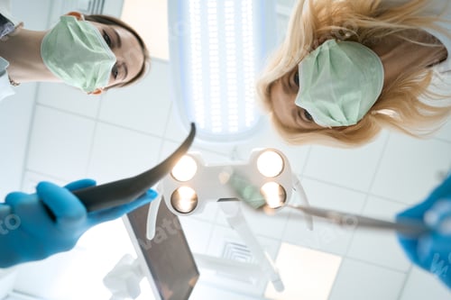 Preview: Dentist and assistant preparing to treat patient