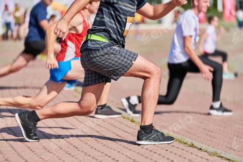 Preview: Young woman warming up before running marathon
