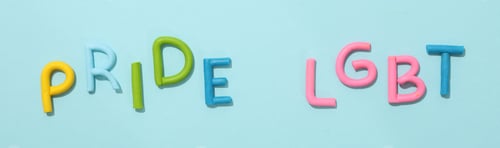Preview: LGBT parade concept, festive colorful symbols on blue background.