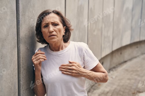Preview: Active aged woman having heart attack outdoors