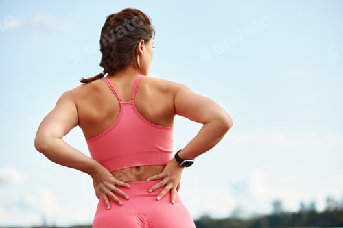 Preview: Attractive athletic woman exercising outdoors in the morning. Young beautiful woman with a slim