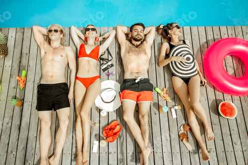 Preview: Friends sunbathing on the swimming pool
