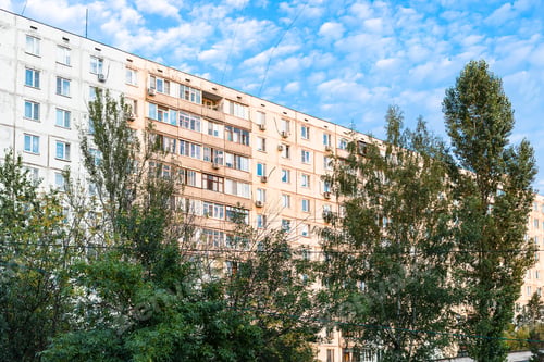 Preview: sunlit residential multi-storey building and trees
