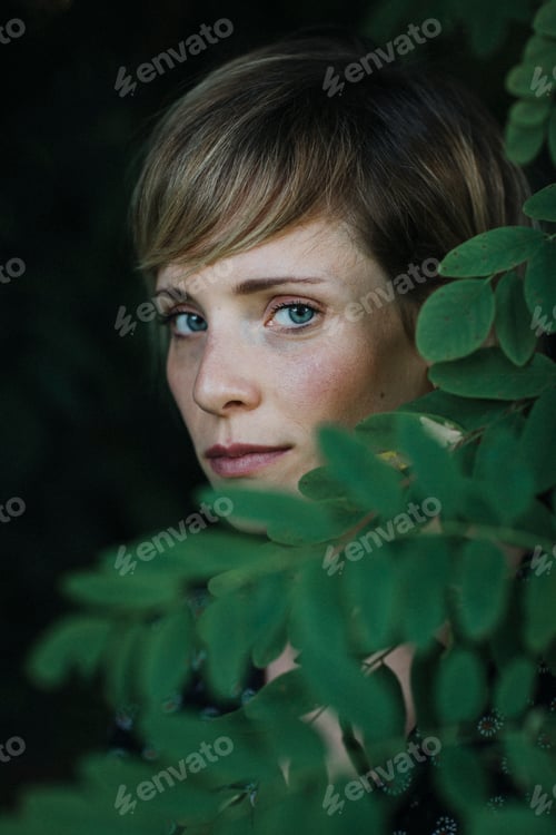 Preview: Portrait of a woman behind leaves
