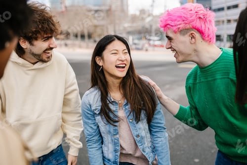 Preview: Young multiracial group of friends talking and laughing in the city