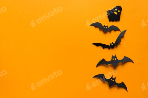 Preview: Halloween decorations, paper bats in ghosts flying on orange background.