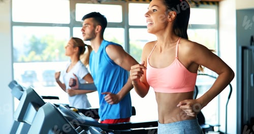 Preview: Group of friends exercising on treadmill machine