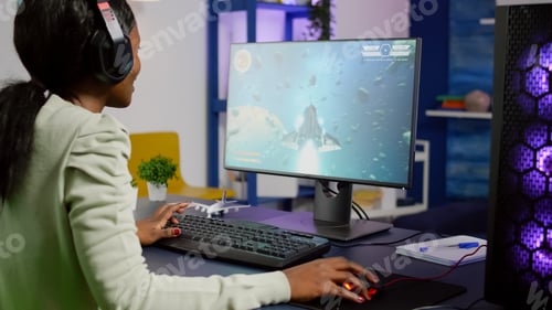 Preview: Pro black woman gamer playing space shooter videogame
