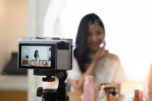 Preview: Young beautiful Asian woman and professional beauty make up artist vlogger or blogger recording
