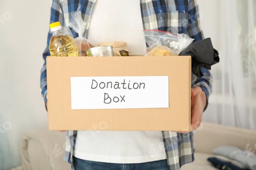 Preview: Young man holds donation box. Volunteer. Covid 19
