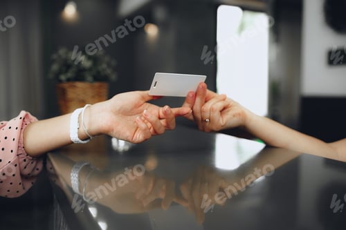 Preview: Hotel receptionist giving key-card to a client at front desk