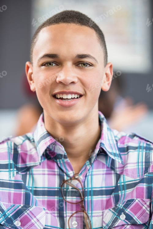 Preview: Smiling young man in a plaid shirt.