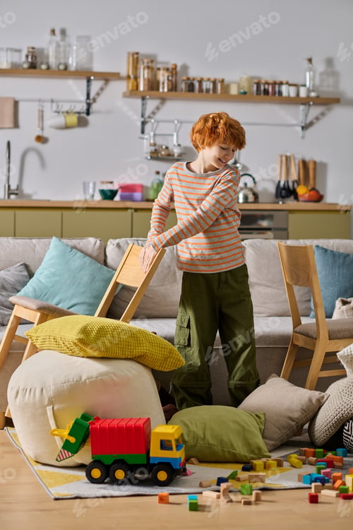 Preview: Little boy joyfully playing with toys in a cozy, colorful living space filled with happiness