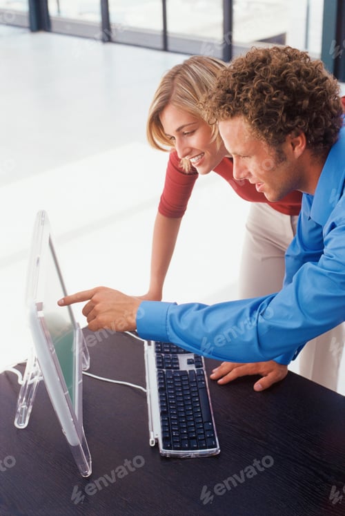 Preview: Business people using computer together