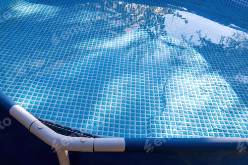 Preview: Swimming pool with metal structure, blue bottom, and space for text