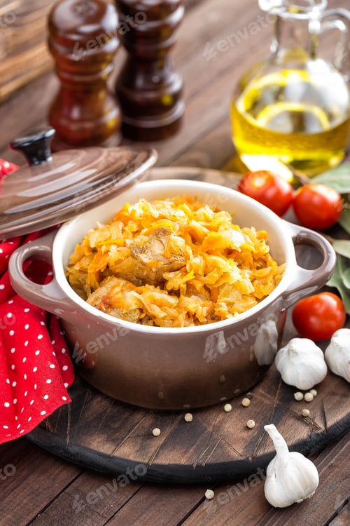 Preview: Stewed cabbage with meat on dark rustic wooden background