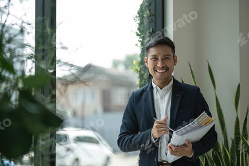 Preview: Portrait of a young businessman with work documents Successful businessman managing business