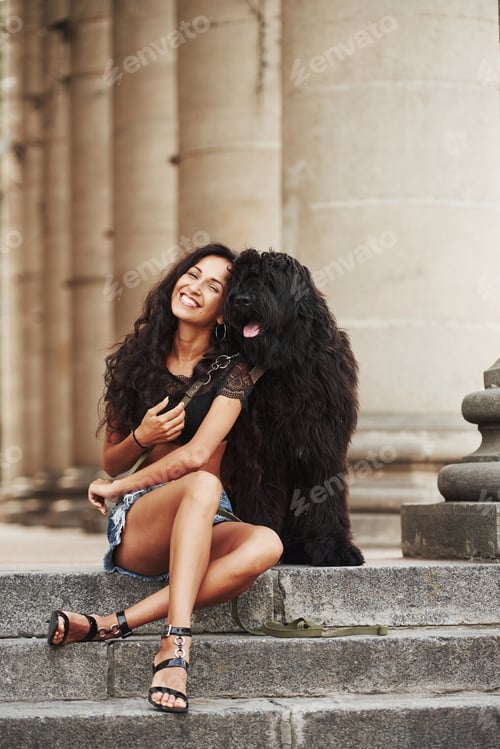 Preview: Dog owner. Beautiful woman with curly black hair have good time in the city at daytime