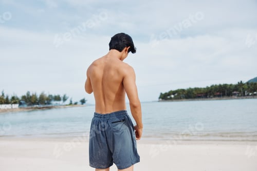 Preview: Muscular Asian Man Running on the Beach: Active Lifestyle and Fitness at Sunset