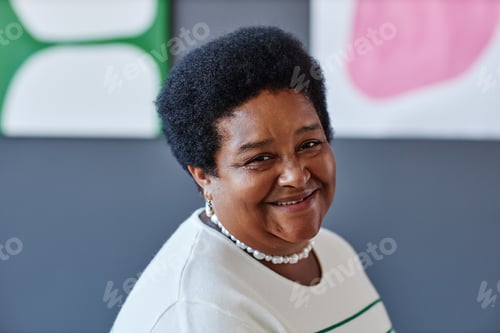 Preview: Happy mature African American woman looking at camera with smile