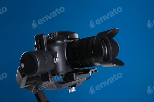 Preview: Modern professional video camera on blue background