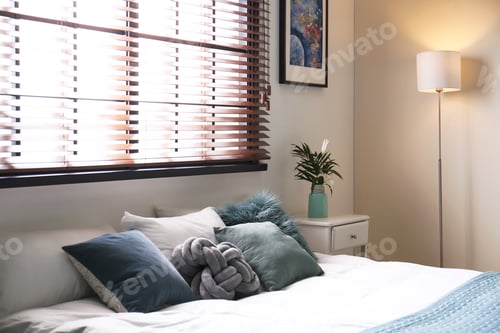 Preview: Modern room interior with comfortable double bed and window blinds