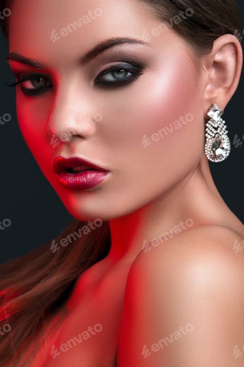 Preview: Woman with beautiful earrings in red light