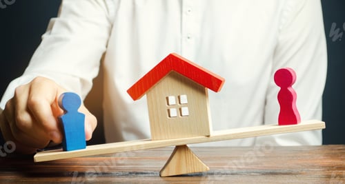Preview: Wooden figures of a man and a woman on scales and a house between them