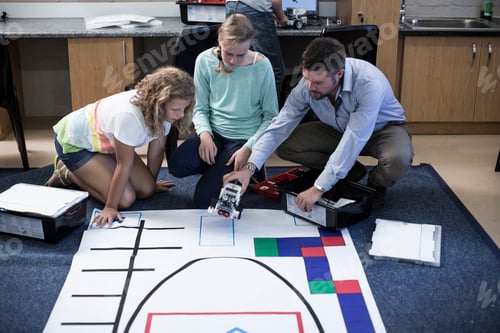 Preview: Teacher with schoolgirls on test track in robotics class