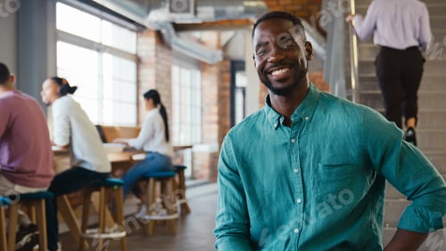 Preview: Portrait Of Smiling Businessman Working In Busy Modern Open Plan Office
