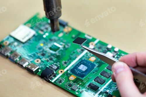 Preview: Repairing a computer chip with a soldering iron.