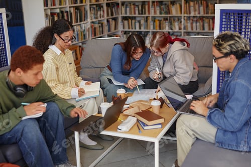 Preview: Diverse Group of Teenagers Collaborating on Project in Modern Library Setting