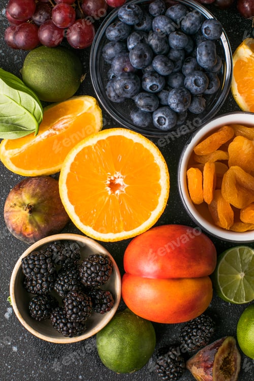 Preview: Assortment of fresh exotic fruits and berries on concrete table, flat lay